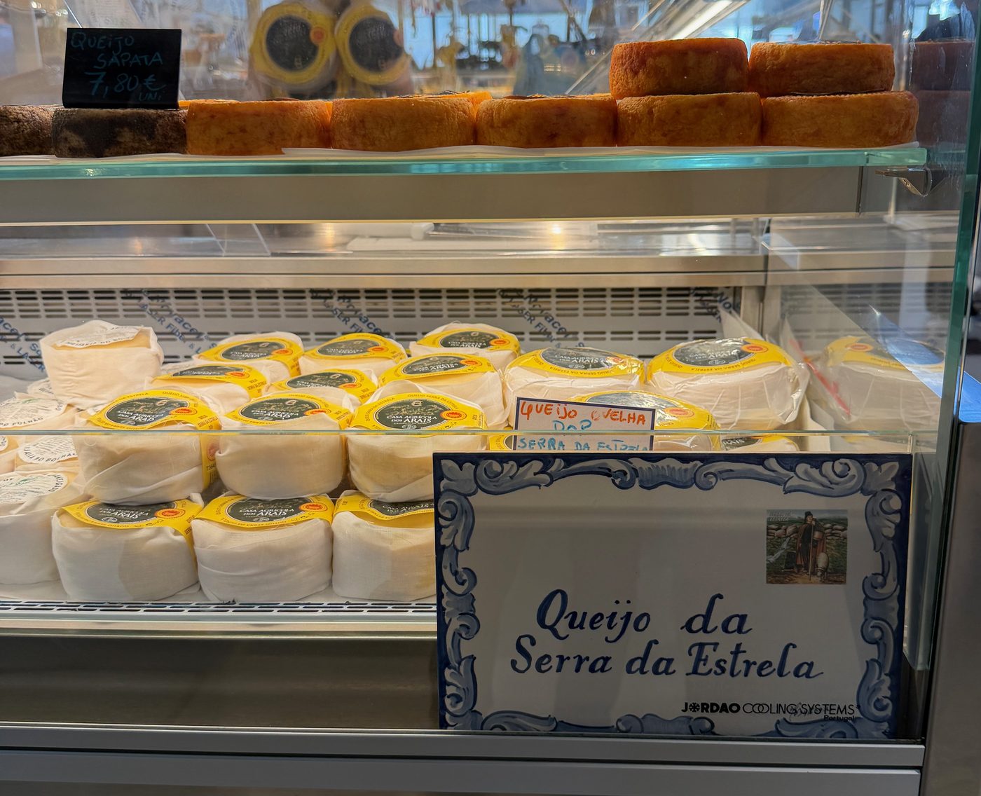 Mercado do Bolhão, Serra da Estrela cheeses at a market stall, October 2026
