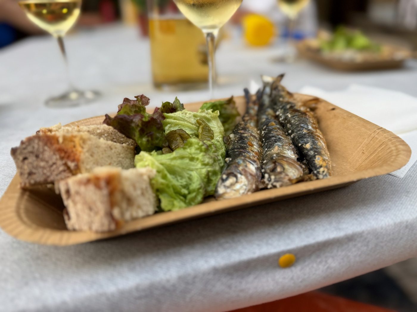 Grilled sardines on bread with salad on São João night in Porto
