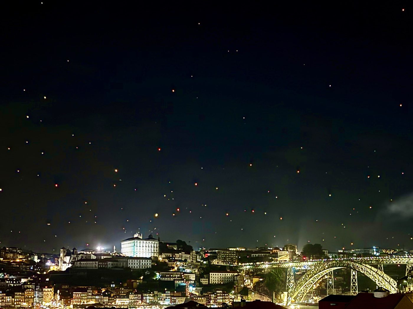 Hundreds of São João sky lanterns over Porto and the Dom Luís I bridge, seen from Gaia